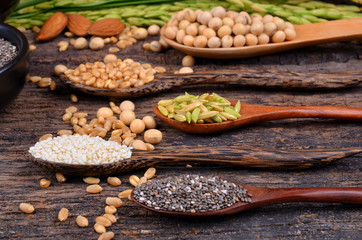 Cereal grains , seeds, beans on wooden background.