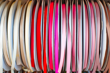 Rep and satin ribbons hanging in large reels. 