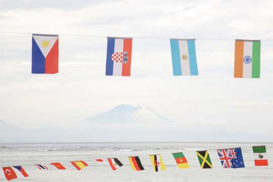 Many different flags against blue sky