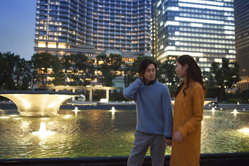 The couple have been dating holding hands in the night of the park