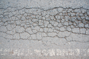 close up Cracked asphalt road in Thailand