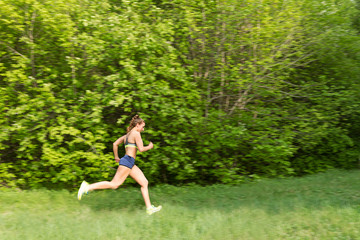 Obraz na płótnie Canvas Young sports girl running, jogging
