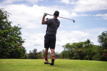 Golfer taking a bad swing off the tee, shanking the ball