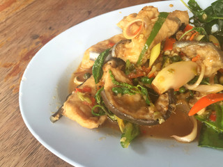 horizontal photo of fried spicy Mekong giant catfish with herb 
