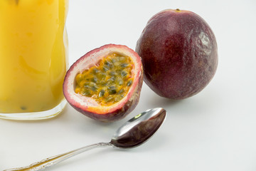 Fresh passion fruit juice with passion fruits on white