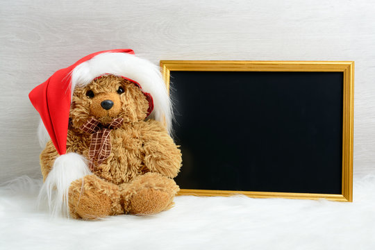 Teddy bear next to the picture in the frame