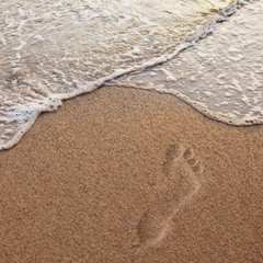 footprints on the beach sand.