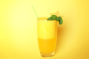 Carambola smoothie on color background