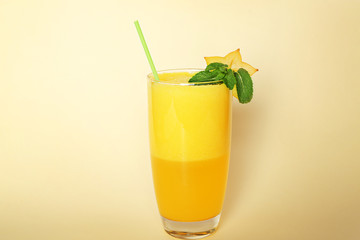 Carambola smoothie on color background