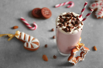 Delicious milkshake with Christmas decoration on grey textured background