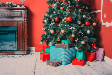 Beautiful new year room with decorated Christmas tree, gifts and fireplace. The idea for postcards. Soft focus. Shallow DOF