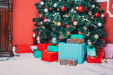 Beautiful new year room with decorated Christmas tree, gifts and fireplace. The idea for postcards. Soft focus. Shallow DOF