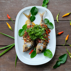 fried mackerel fish and chilli sauce on white plate
