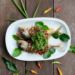fried mackerel fish and chilli sauce on white plate