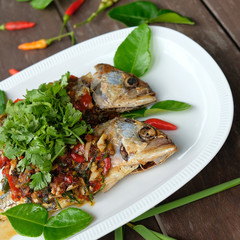 fried mackerel fish and chilli sauce on white plate