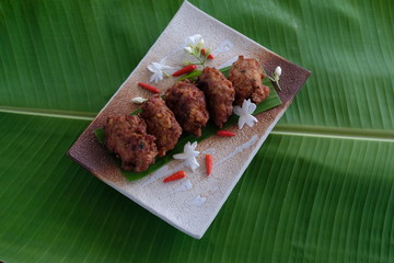 Fried  minced pork  ball on plate and banana leaf
