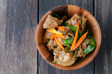 Stir fried chicken with spicy curry paste on wood plate/ Thai fo