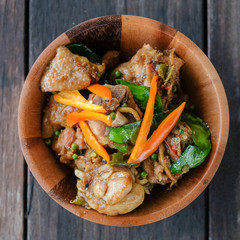 Stir fried chicken with spicy curry paste on wood plate/ Thai fo
