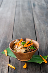 Stir fried chicken with spicy curry paste on wood plate/ Thai fo