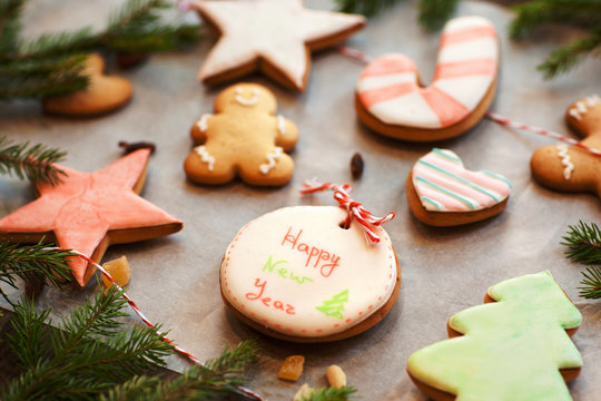 Sweet colorful gingerbread cookies background. Assortment of traditional Christmas food, one with happy new year greeting. Holiday, winter, pastry concept