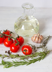 tomato with olive oil on wooden background