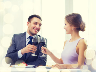 couple with main course and red wine at restaurant
