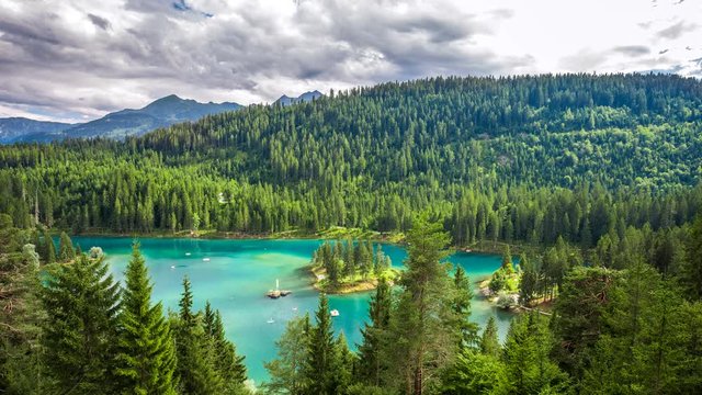 Green forest and Swiss Alps surrouding Caumasee, Flims, Graubuenden, Switzerland. 4K dramatic timelapse