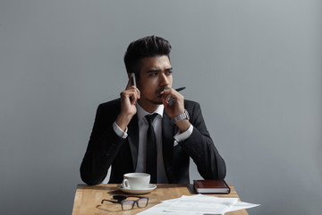 A beautiful successful man talking on phone office in cafe