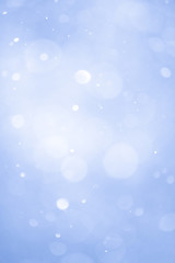Abstract Blue Christmas Background with Real Snow. Blurred Snowflakes.