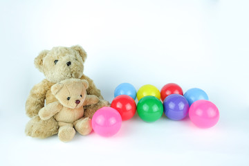 Brown bear dolls with colorful balls. White background.