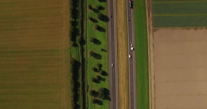 Cars on road from above in typical Dutch landscape