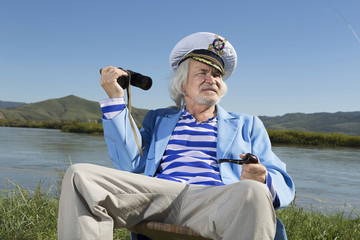 Captain looks through binoculars