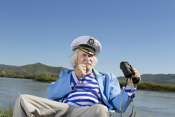 Captain looks through binoculars