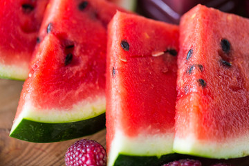 close up of watermelon slices on wooden table