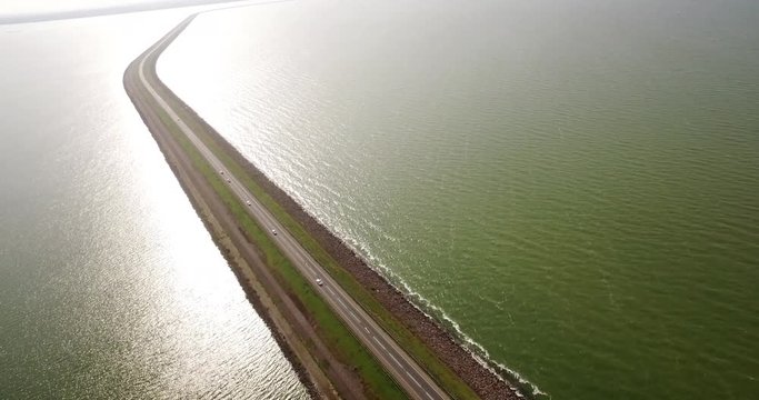Dutch dikes with roads and cars between the Markermeer and the IJsselmeer in The Netherlands