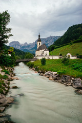 Fototapeta na wymiar The Church of St. Sebastian against alpine mountains, Germany