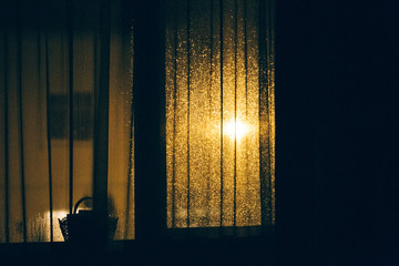 Night Street View with Yellow Lantern through a Window