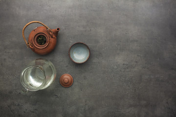 Green tea accessories on kitchen table. 