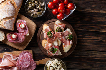 Spanish tapas with slices jamon serrano, salami, olives and chee