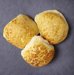 Freshly baked bread rolls on a rustic slate background