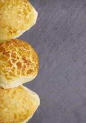 Freshly baked bread rolls arranged on a rustic slate background to form a page border