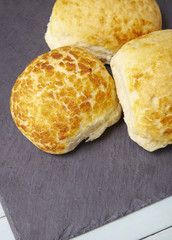 Freshly baked bread rolls on a wooden breakfast table background