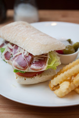 Sandwich with ham, cheese, fresh tomato and green salad