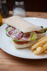 Sandwich with ham, cheese, fresh tomato and green salad