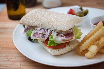 Sandwich with ham, cheese, fresh tomato and green salad