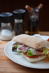 Sandwich with ham, cheese, fresh tomato and green salad
