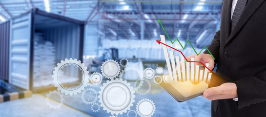 Business hand holding growth chart of transport business on tablet with supply chain management ,Logistic Import Export background