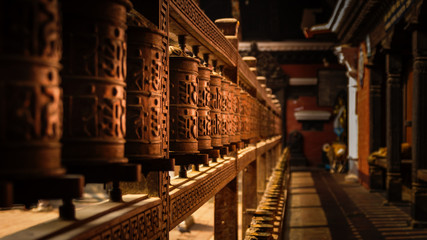 Wooden Prayer Wheels in a temple in Kathmandu, Nepal - obrazy, fototapety, plakaty