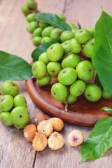 dried figs and fresh fruit on a wooden table. (ficus carica, ficus racemosa, ficus glomerata)