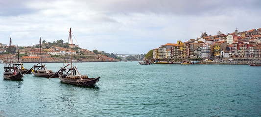 Douro river rabelos boat Porto Oporto wine barrel historic cityscape embankment background panorama